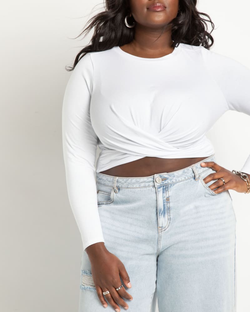 Front of a model wearing a size 26 Long Sleeve Tee With Twist in True White by ELOQUII. | dia_product_style_image_id:272753